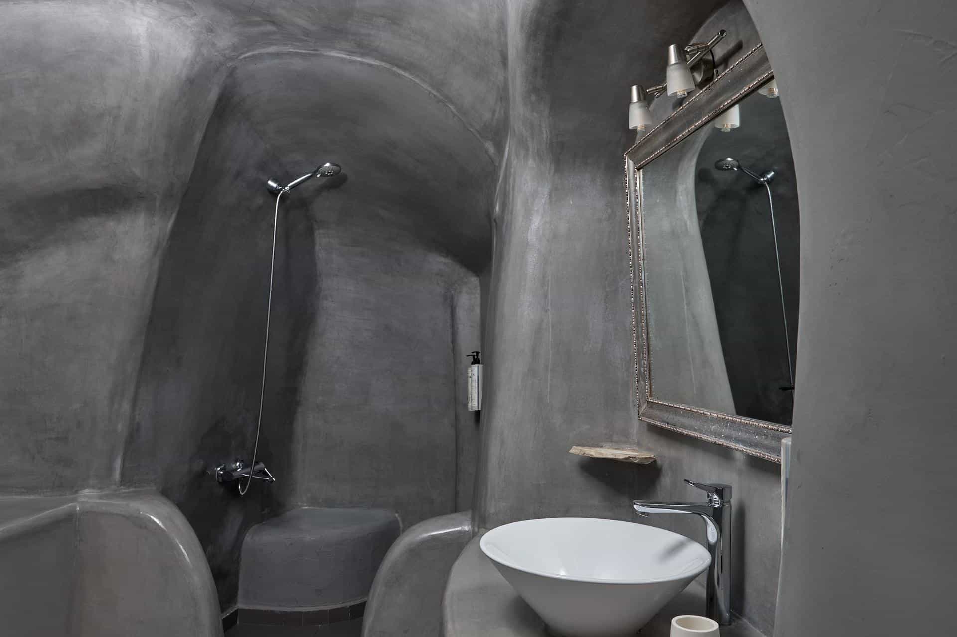 Cave-style bathroom with grey stone shower and basin