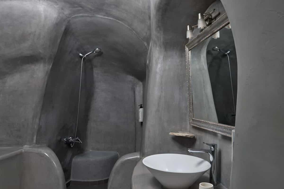 Cave-style bathroom with grey stone shower and basin