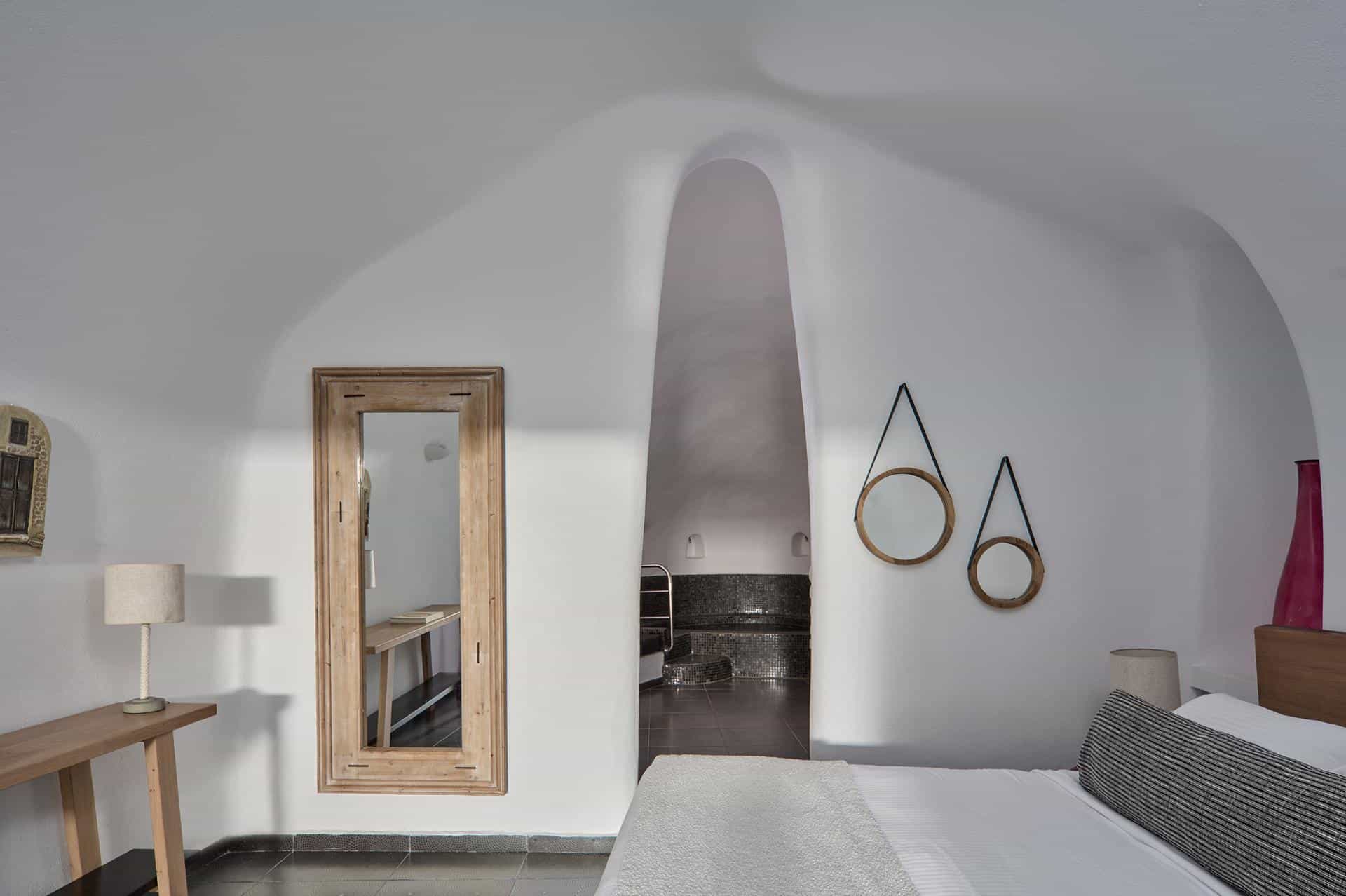 Cave suite detail with whitewashed walls and warm ambient light