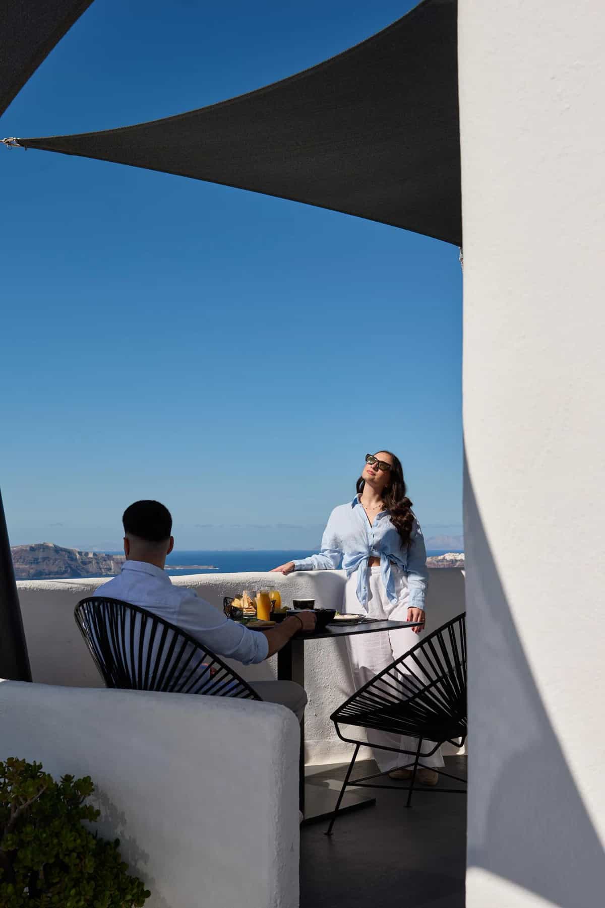 Romantic couple portrait with Santorini caldera backdrop