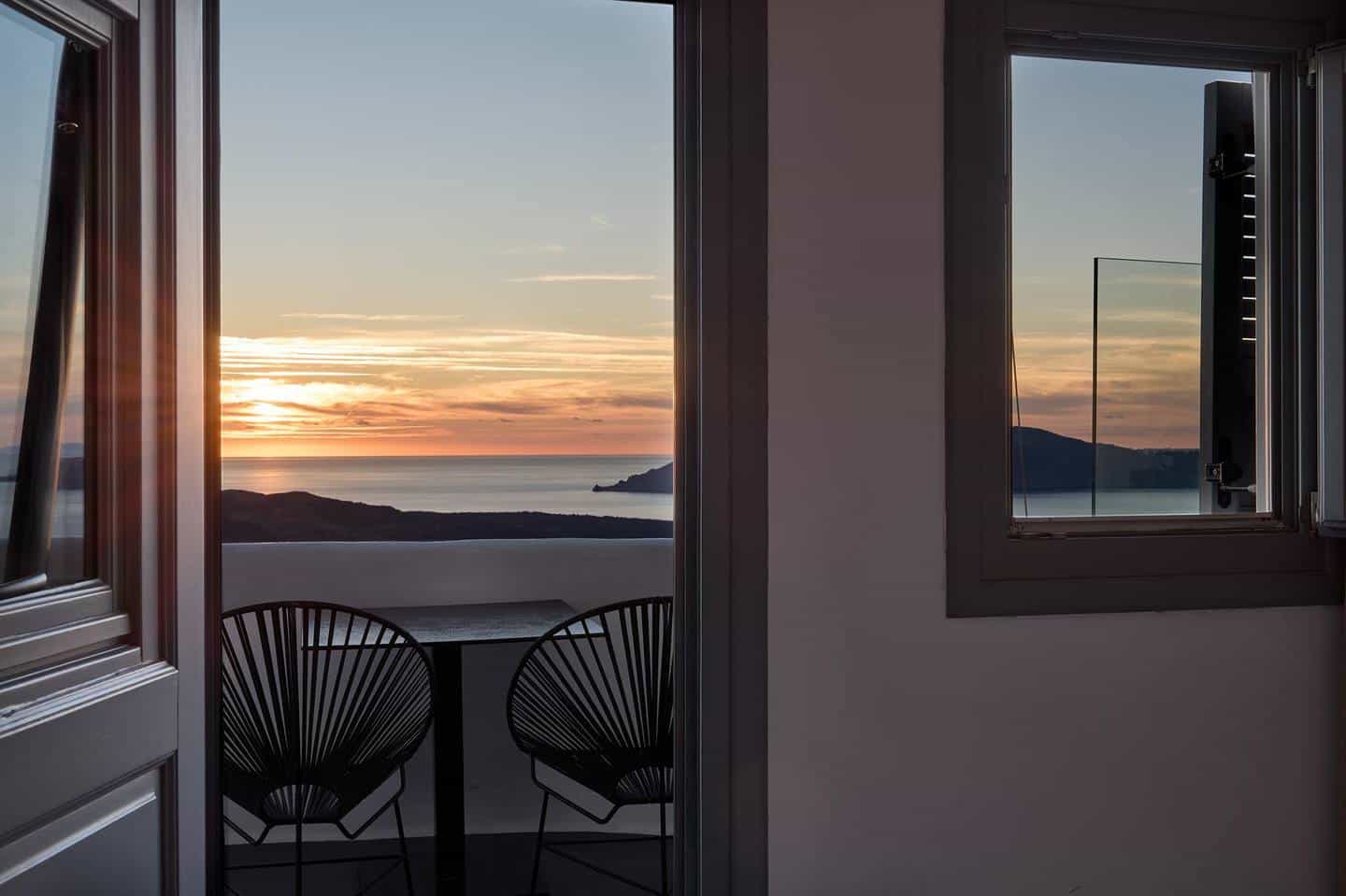 Sunset view from inside room through open door to balcony