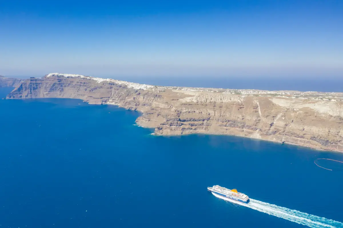Ferry sailing into the Santorini caldera below the cliffs