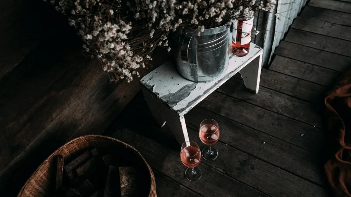 Wine glasses on an outdoor terrace at one of the best wineries in Santorini with vineyard views
