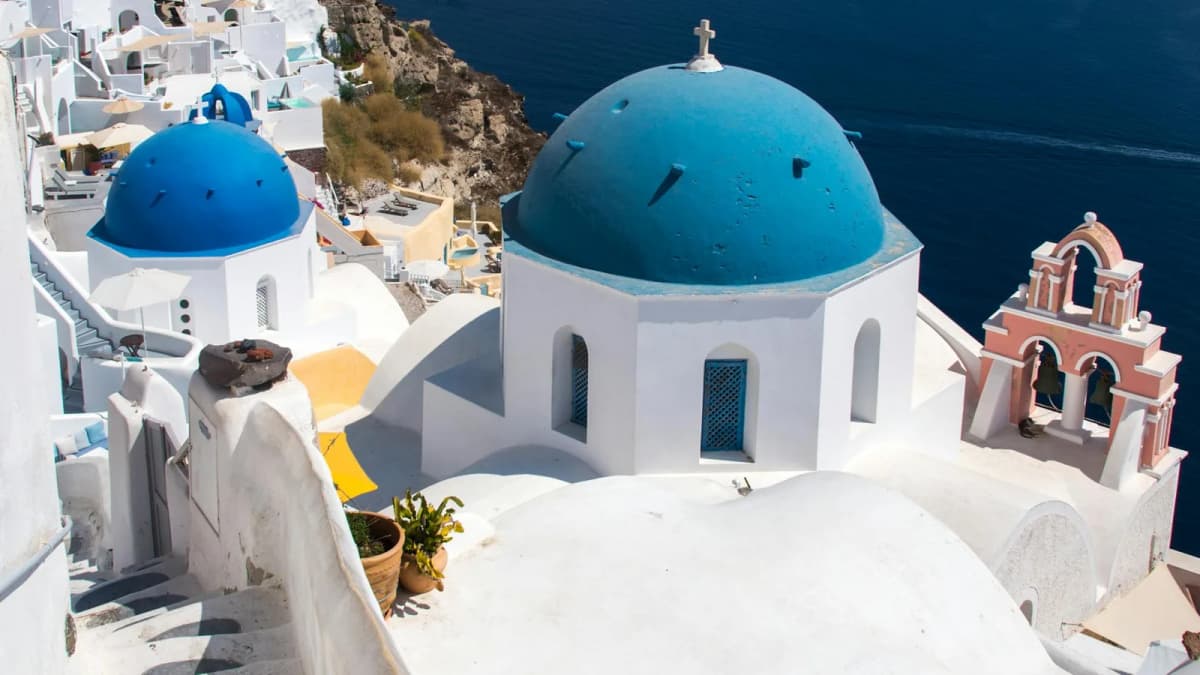 Blue dome church in Firostefani Santorini overlooking the caldera and Aegean Sea
