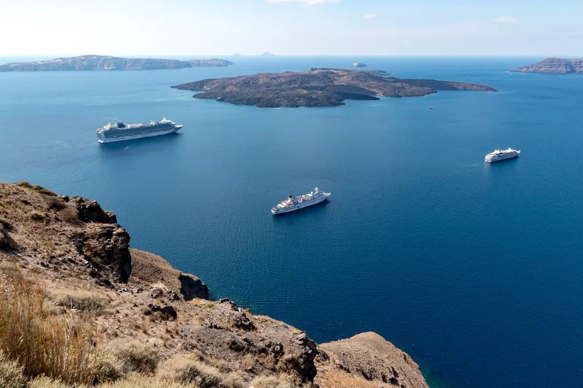 The Santorini caldera seen from the cliffs above Fira, with the volcanic island of Nea Kameni in the middle and cruise ships at anchor