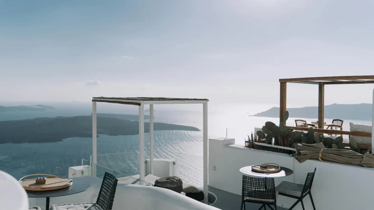 Luxury hotel terrace overlooking the Santorini caldera with romantic sunset views for couples