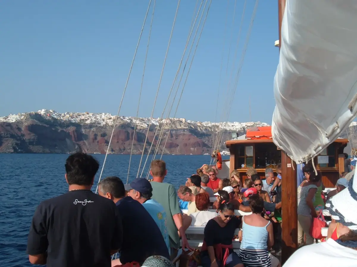 Passengers on a sailing boat heading to Oia across the Santorini caldera