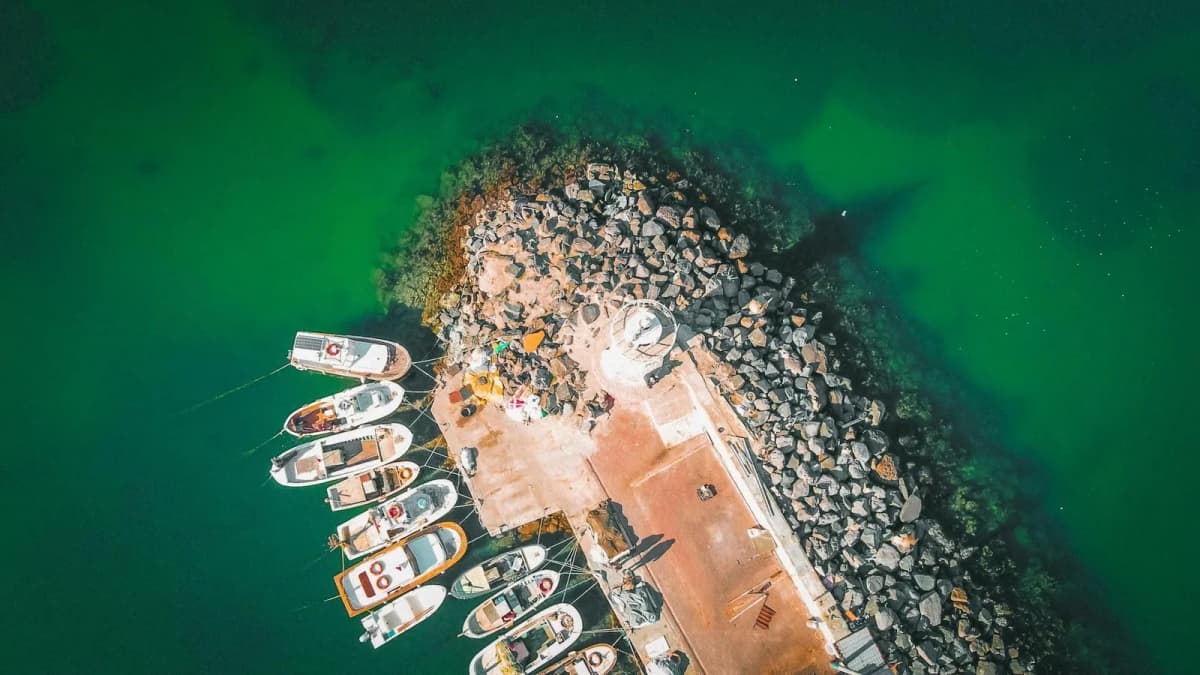 Cruise ship approaching Santorini with whitewashed caldera villages above