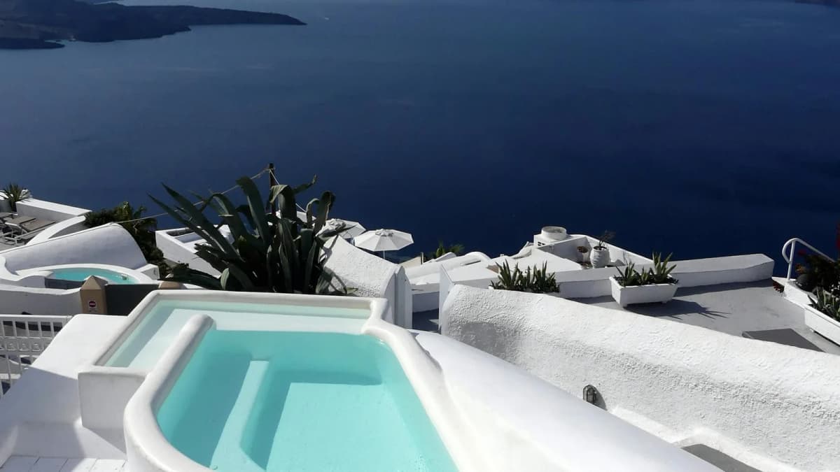 Luxury pool with Aegean Sea and caldera views at a Santorini hotel in Fira