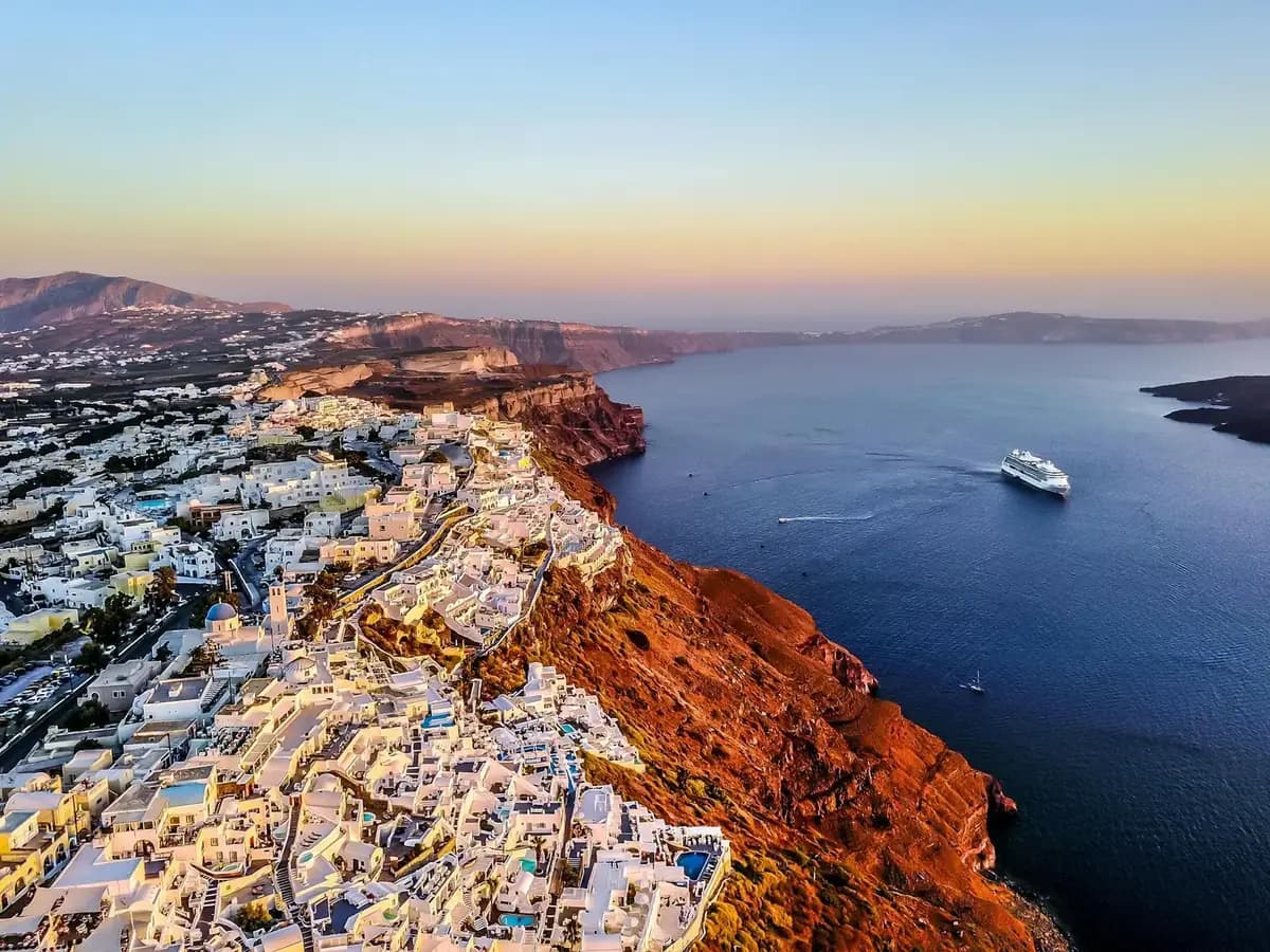 Iconic Santorini blue dome churches with white buildings overlooking the caldera