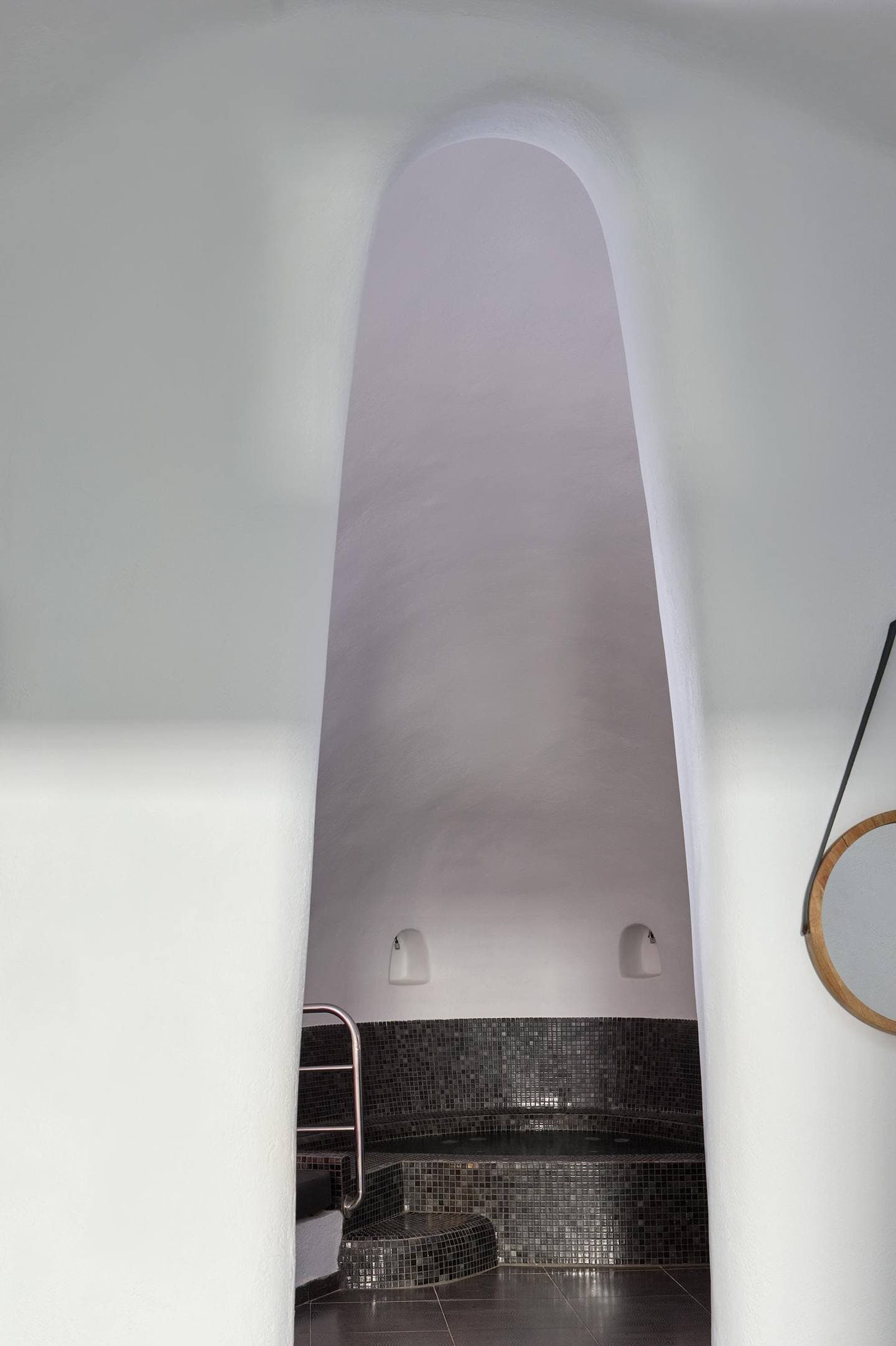 Cave suite with indoor heated jacuzzi and mosaic tiles at Aroma Suites Santorini