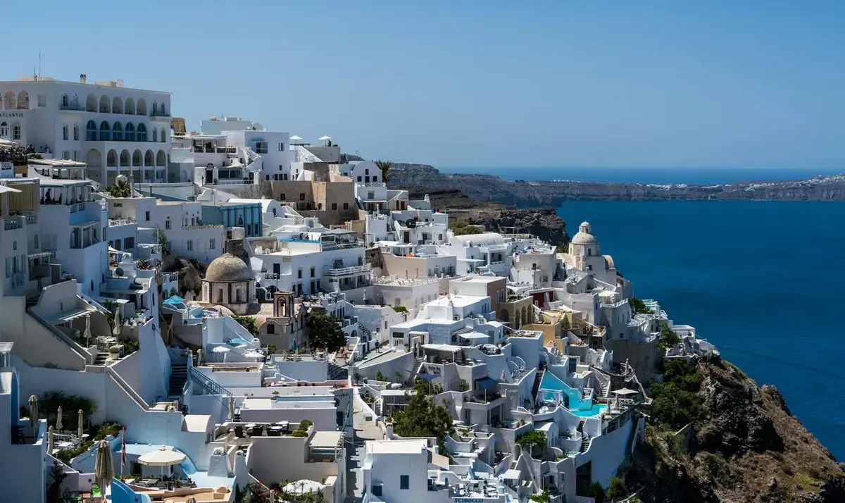 Fira town on the caldera edge on a clear day, with whitewashed buildings and church domes