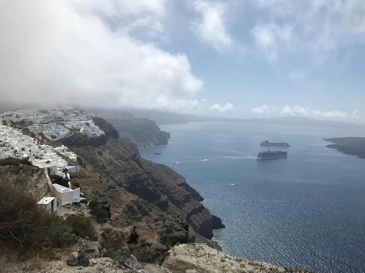Firostefani and Fira along the caldera cliff from the path, two cruise ships below