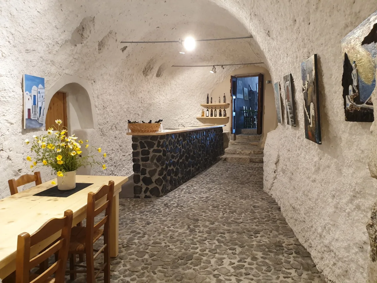 Art Space Winery cave cellar with art installations in Exo Gonia, Santorini