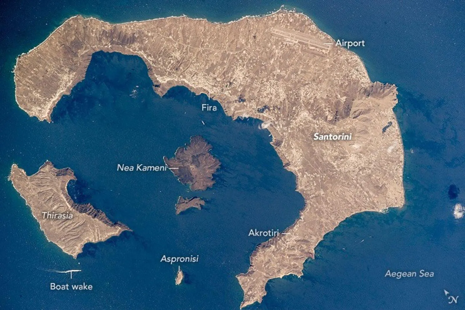 NASA satellite image of Santorini island showing the crescent-shaped caldera from space