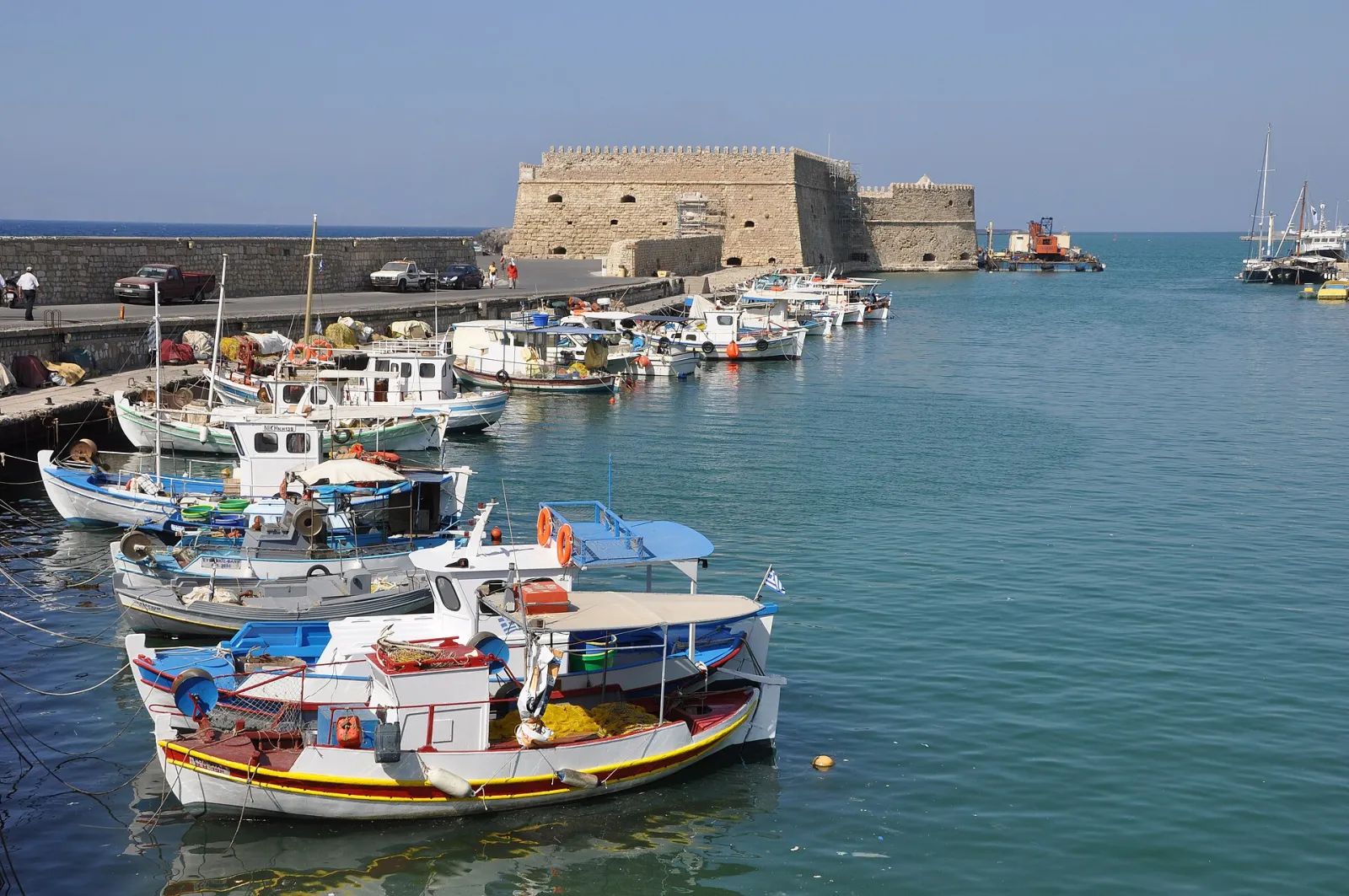 The Venetian Koules fortress guarding Heraklion harbour in Crete, with fishing boats in the foreground