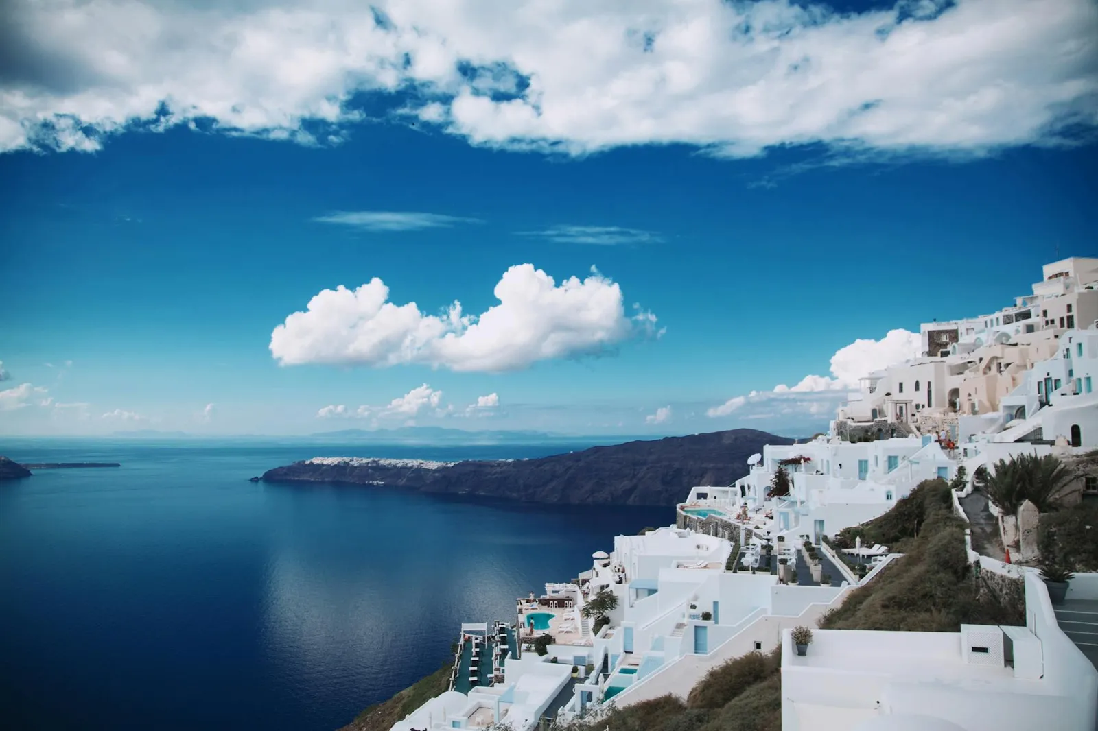 Panoramic view of the Santorini caldera with whitewashed buildings and blue Aegean Sea