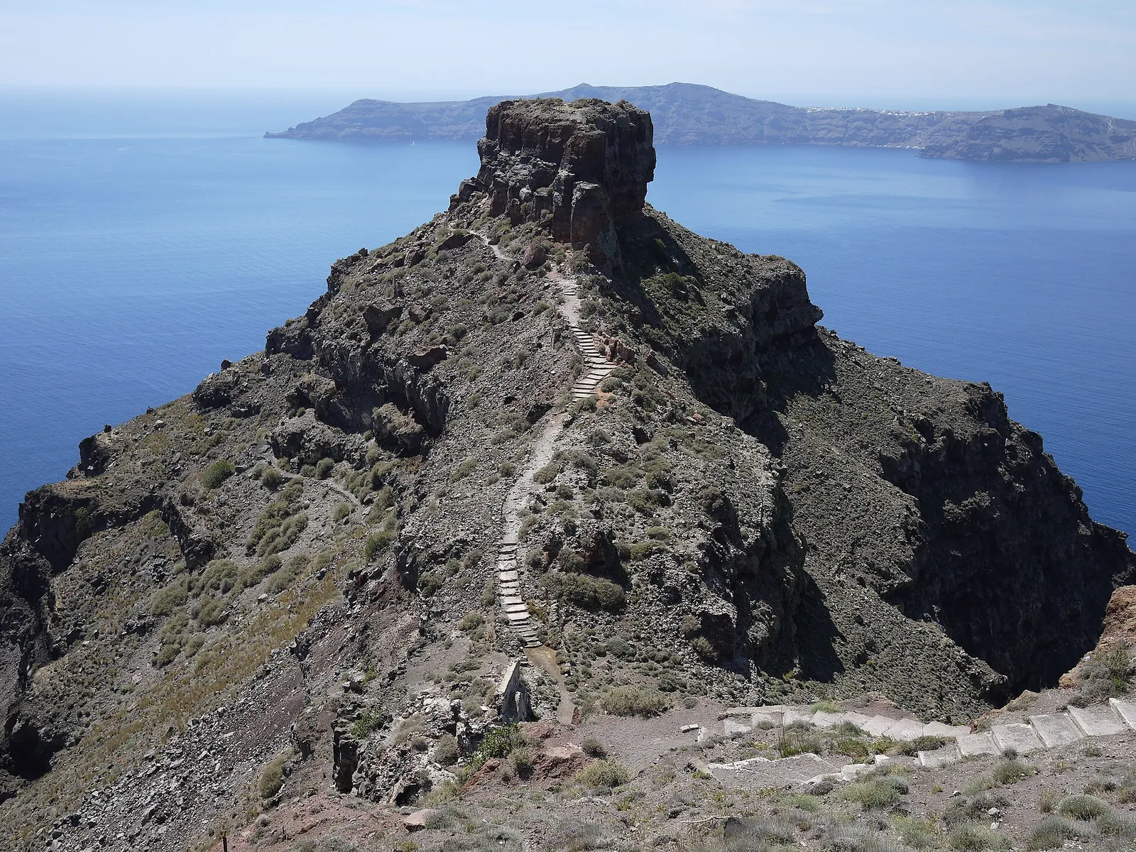 The stepped trail running down and out along the ridge to Skaros Rock, Thirasia behind
