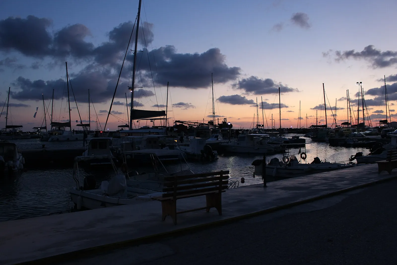 Sailing boats moored in Vlychada marina at dusk